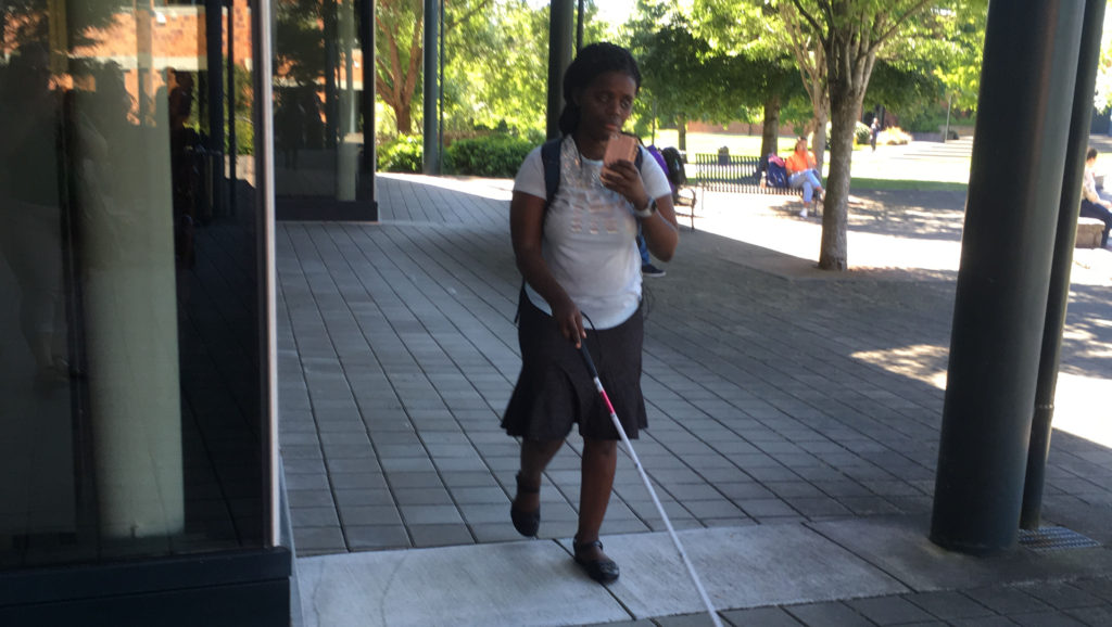 Abby uses assistive technology on her cell phone to locate specific buildings on the Washington State University Campus
